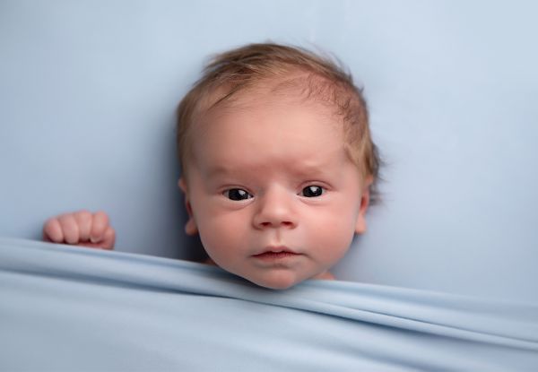 Wide awake baby at newborn photo shoot in Leeds